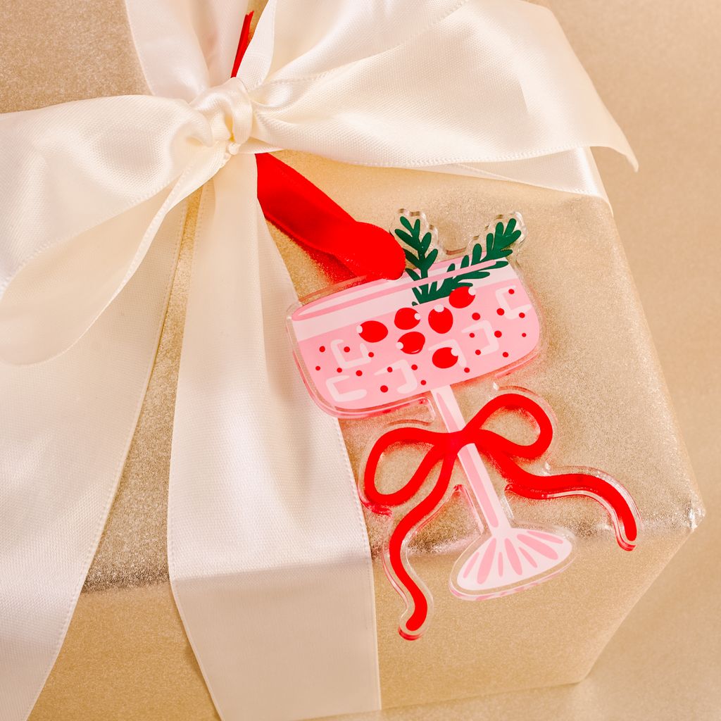 flat ornament of a pink cosmopolitan martini drink tied on a package