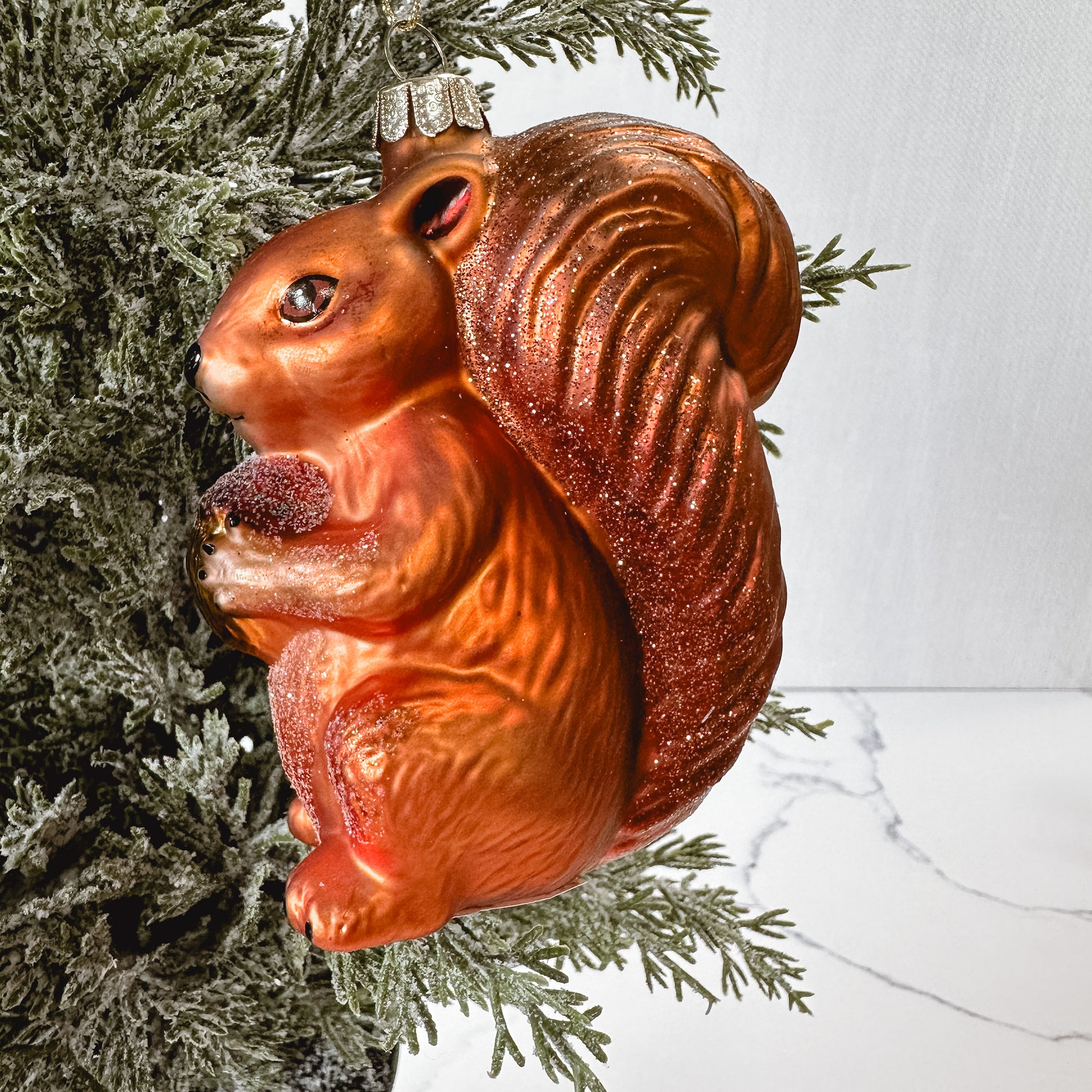 squirrel shaped ornament in a tree.