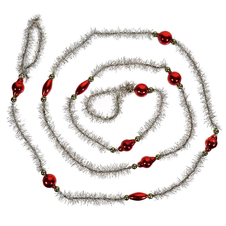 Decorative garland with red beads and silver tinsel swirled on a white background