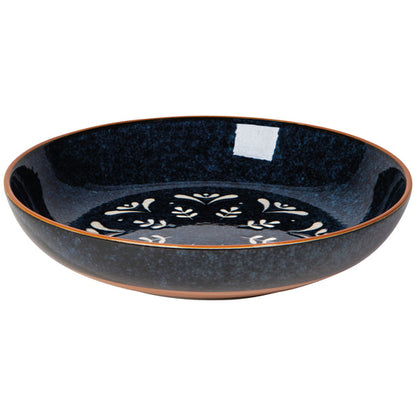 A round, blue stoneware pasta bowl with a mosaic of radial patterns inside.