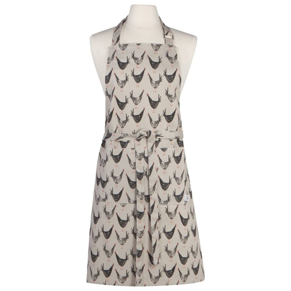 mannequin wearing taupe apron with all-over chicken design printed on it.