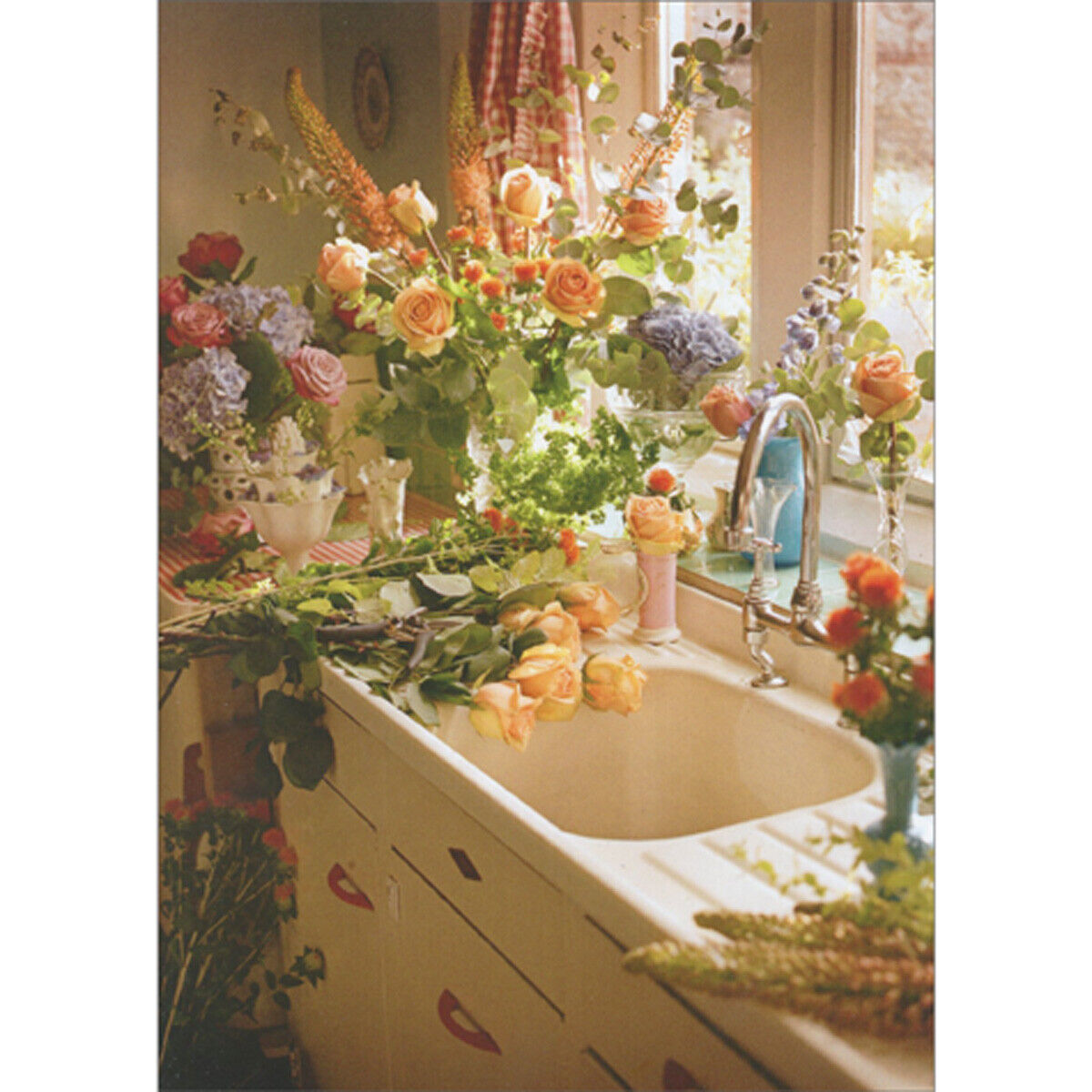 photo of vintage kitchen sink filled with colorful flowers