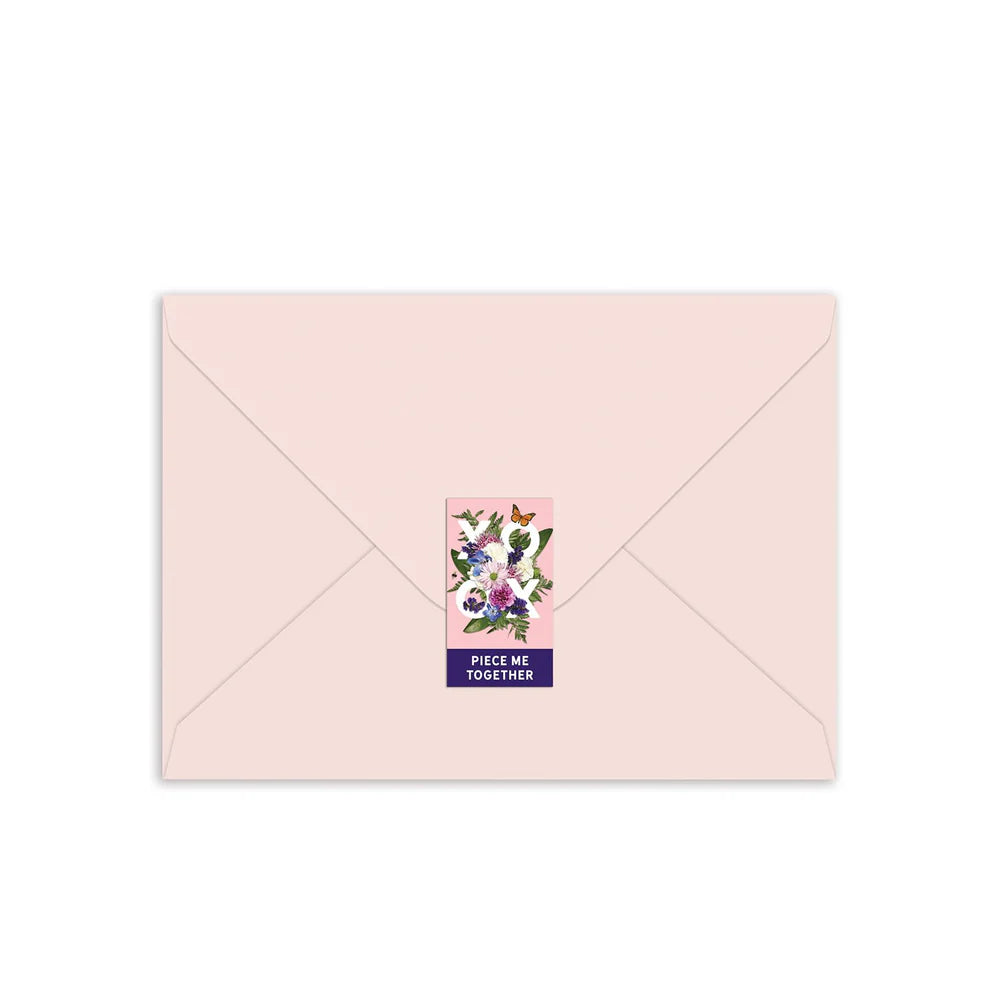 light pink envelope sealed with a sticker.