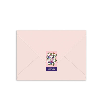 light pink envelope sealed with a sticker.