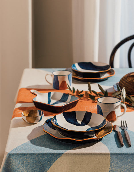 canvas stamped tapas plate displayed in a table setting next to plates, mugs, and flatware