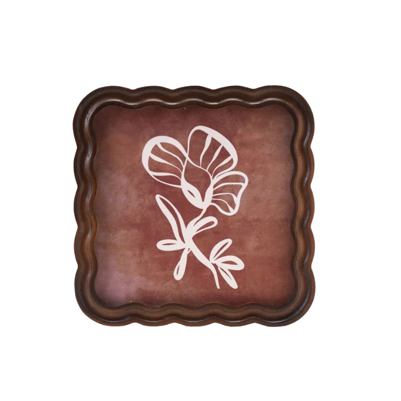 Decorative wood frame with a floral design in it on a white background