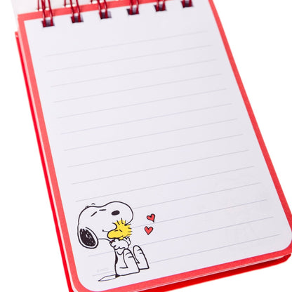 open notebook showing lined pages with snoopy on corner