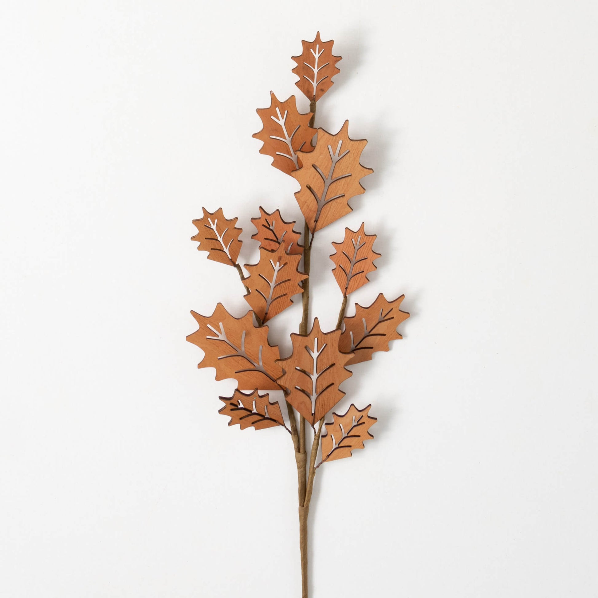 die cut holly leaf spray displayed against a white background