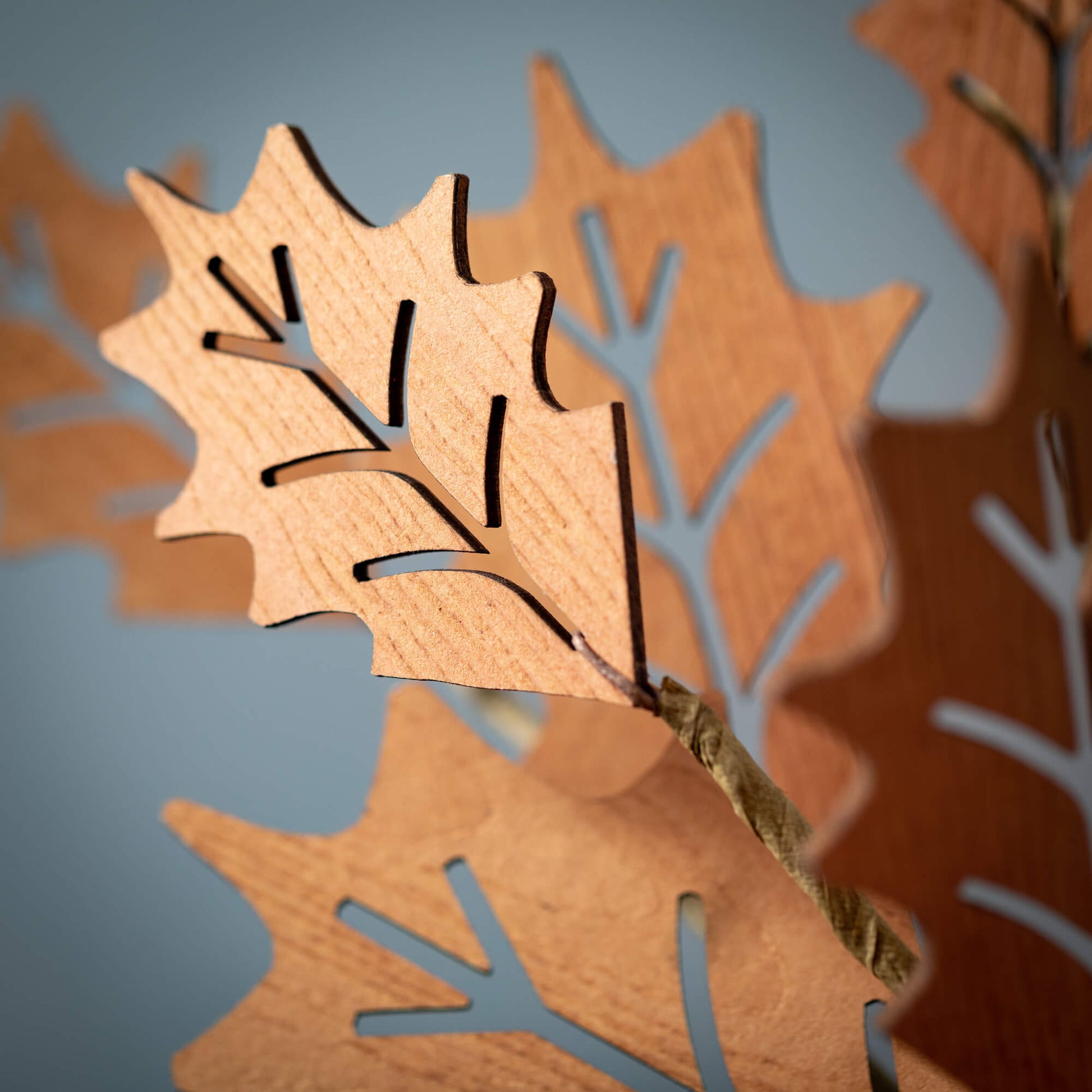 close up view of the die cut wood holly leaf spray