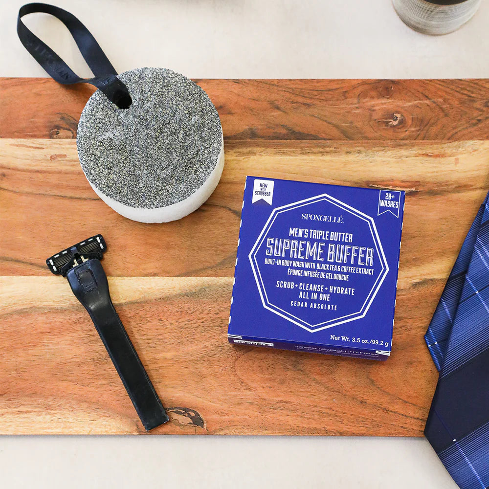 Supreme Buffer packaging with a scrubber and razor on a wooden surface