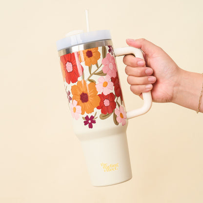 hand holding floral tumbler.