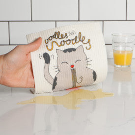 hand wiping counter with Oodles Of Noodles Swedish Sponge Dishcloth.