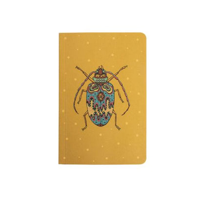 Yellow notebook with light yellow polka dots and a blue and red beetle.