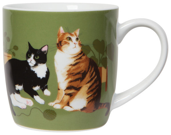 front view of cat collective porcelain mug is green with cats around