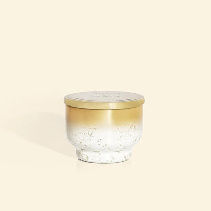 Gold and white volcano inverted jar candle.