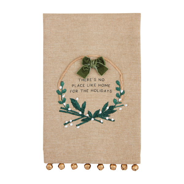 embroidered chambray towel with wreath design and "there's no place like home for the holidays" printed on it.