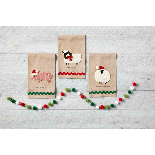 3 styles of farm christmas towels arranged on a wood slat background.