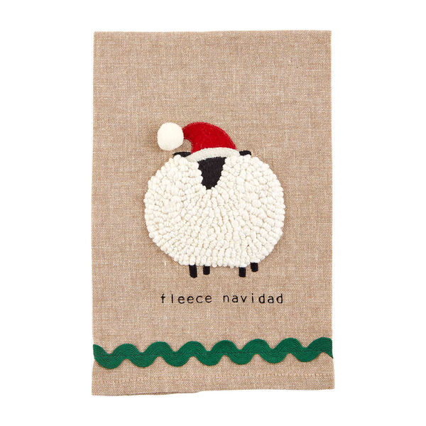 natural color towel with pom sheep embroidered on it with "fleece navidad" printed on it.