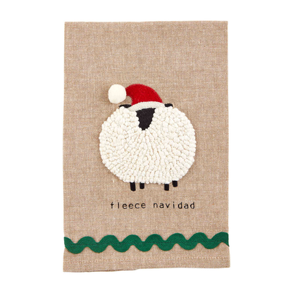 natural color towel with pom sheep embroidered on it with "fleece navidad" printed on it.