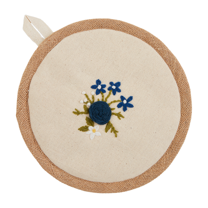 flower bundle potholder with embroidered blue and white flowers in the center.