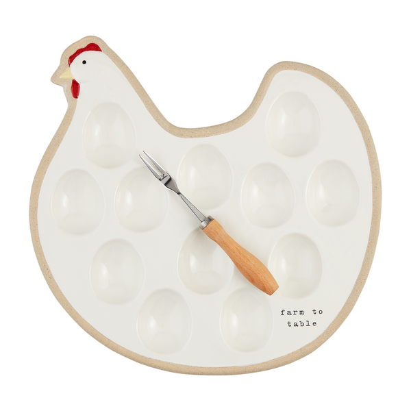 hen shaped plate with 12 egg wells with a wooden handled serving fork set on it.
