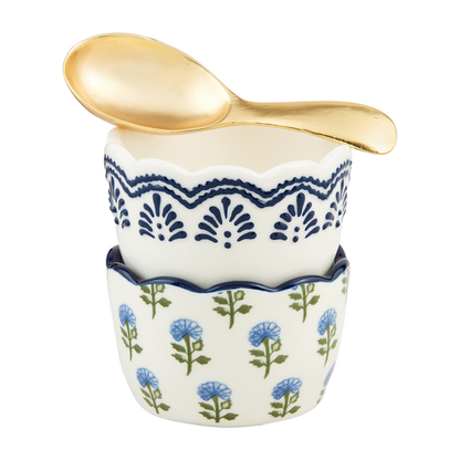 2 ramekins stacked with a gold spoon on top, one ramekin has an all-over blue floral with green stem design, the other has a blue geometric pattern around the rim.
