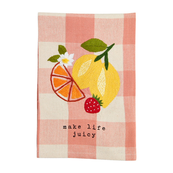 pink check hand towel embroidered with citrus fruits, a strawberry, and a daisy with "make life juicy" printed along the bottom.
