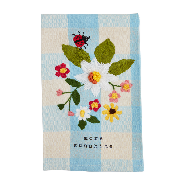 blue check hand towel embroidered with flowers and a ladybug and "more sunshine" printed along the bottom.