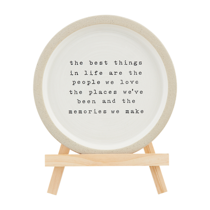plate on stand with text "the best things in life are the people we love, the places we've been and the memories we make" printed on it.