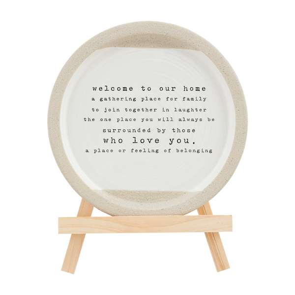 plate on stand printed with "welcome to our home a gathering place for family to join together in laughter the one place you will always be surrounded by those who love you. a place or feeling of belonging".
