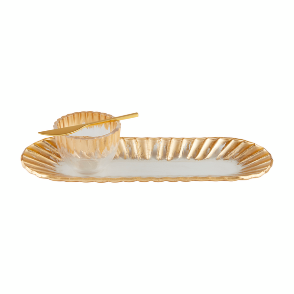 glass tray and bowl with gold rims stacked with a gold spreader on the bowl.