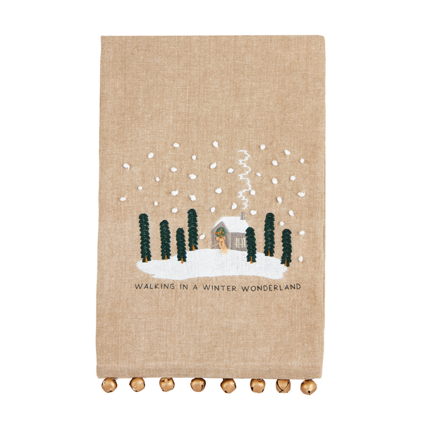 embroidered chambray towel with house and trees design and "walking in a winter wonderland" printed on it.