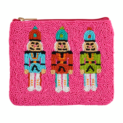 hot pink beaded zipper bag with 3 nutcrackers beaded across the front.