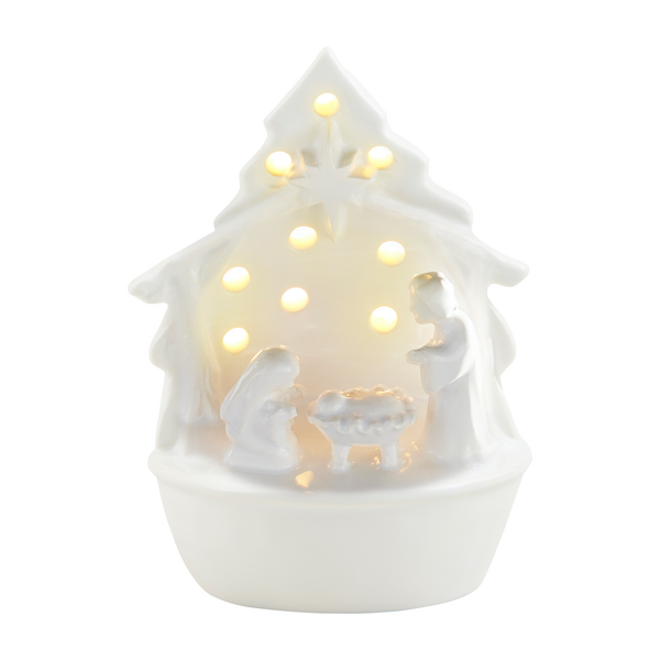 small white ceramic nativity scene with mary, joseph, and Jesus in his manger lit-up from behind the creche.