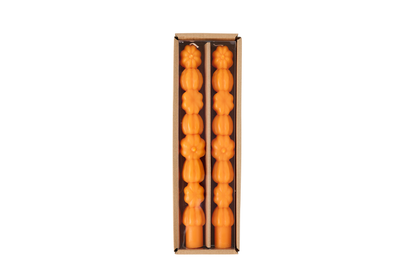 orange pumpkin taper candles in their box packaging.
