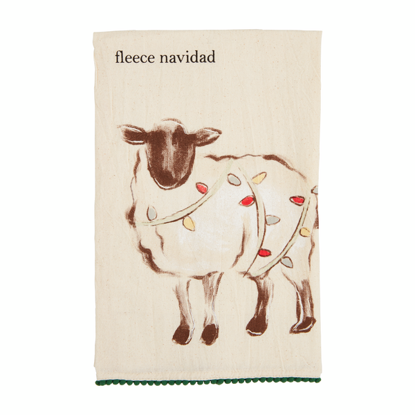 off-white towel with green pom trim with a sheep draped in christmas lights and "fleece nacidad" printed on it.