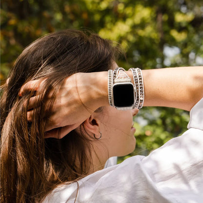 close-up of person running fingers thru their hair and wearing  Labradorite strap on an apple watch.