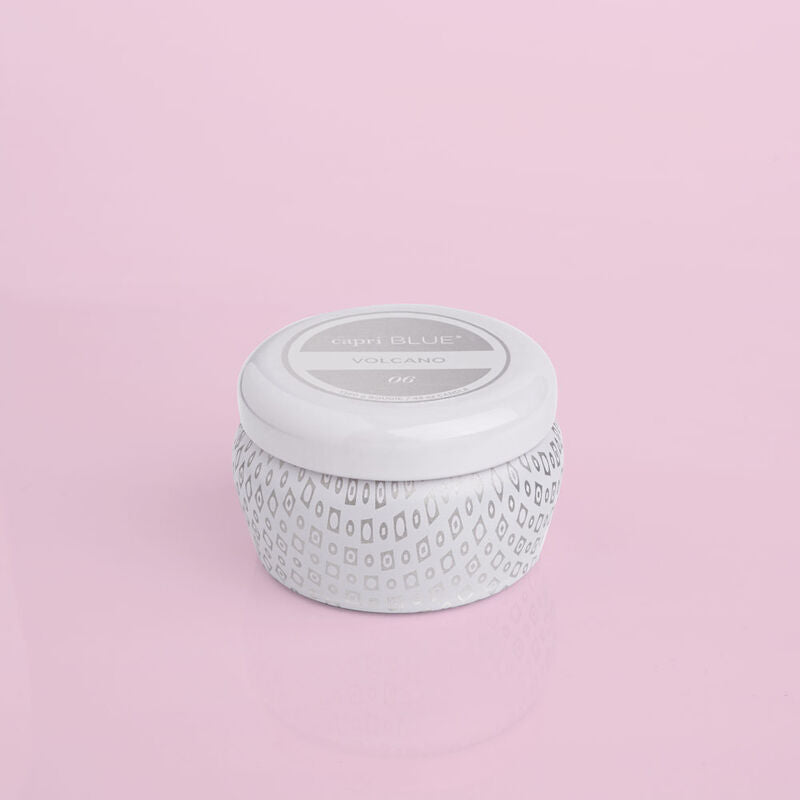 Volcano Signature White Mini Tin Candle on a light pink background.