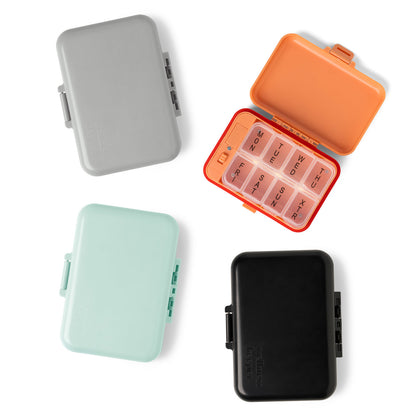 4 colors of Light-Up Pill And Vitamin Cases, orange case in open arranged on a white background