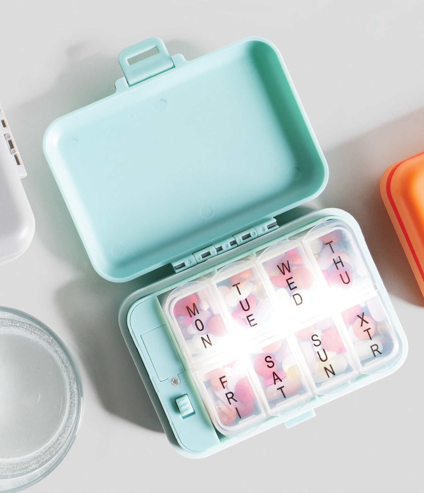 green Light-Up Pill And Vitamin Case open with pills inside