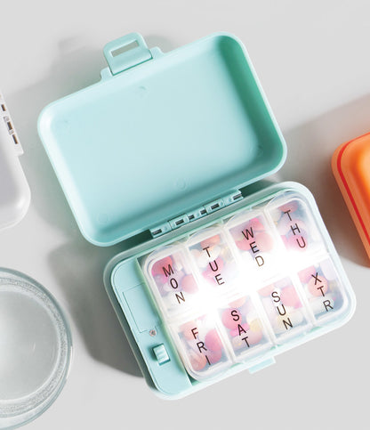 green Light-Up Pill And Vitamin Case open with pills inside