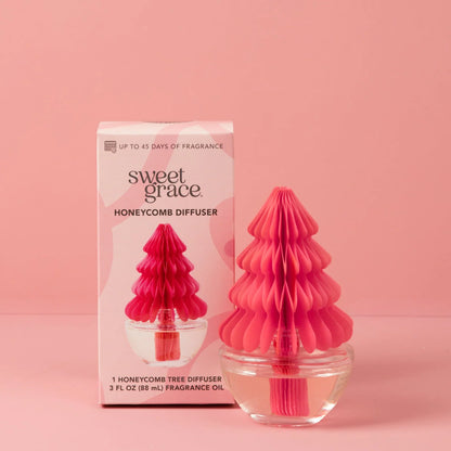 Pink honeycomb tree diffuser with packaging on a pink background
