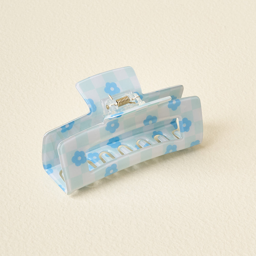 blue check claw clip on an off-white background.