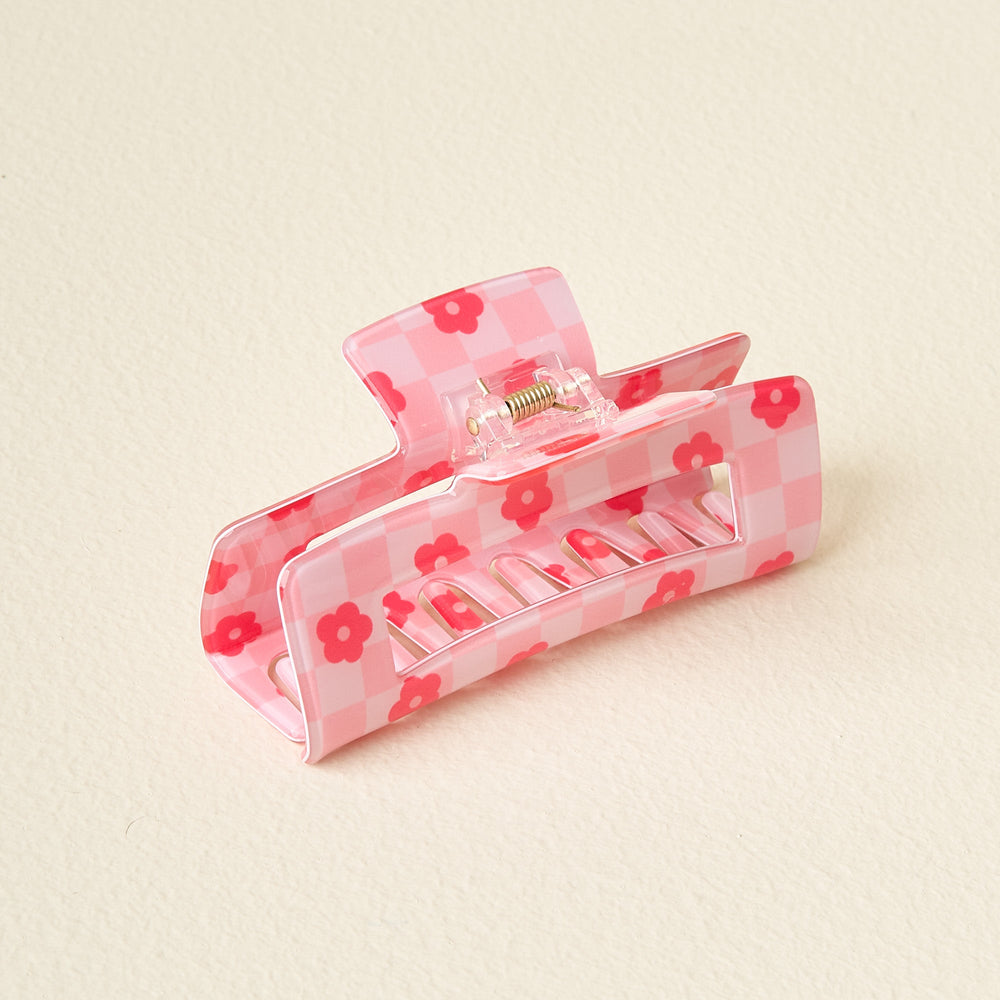 pink check claw clip on an off-white background.