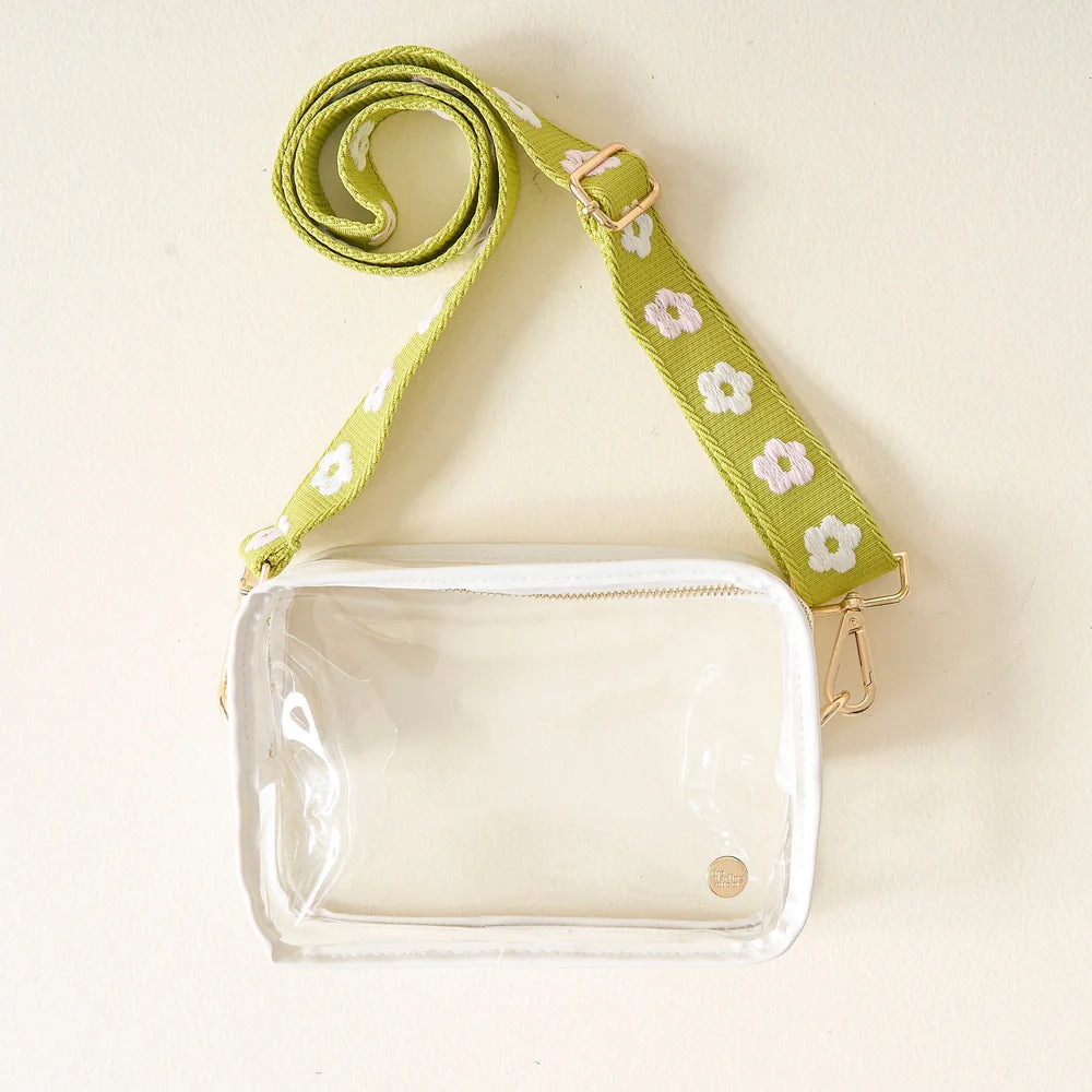 clear bag with green floral strap.