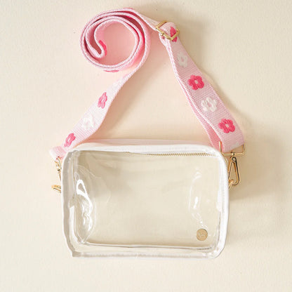 clear bag with pink floral strap.