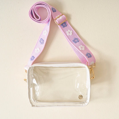 clear bag with purple floral strap.
