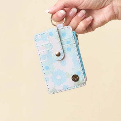 hand holding aqua Daisy Craze Keychain Card Wallet by the keyring.