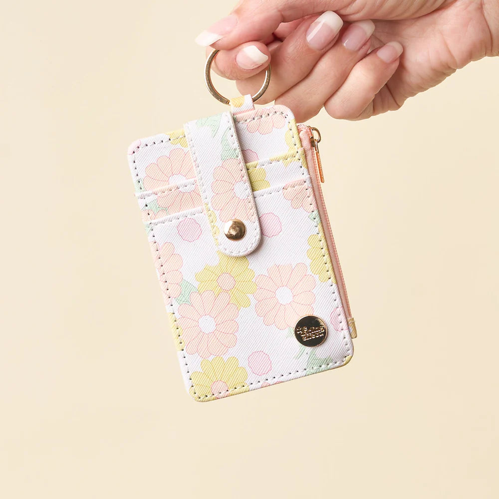 hand holding peach Daisy Craze Keychain Card Wallet by the keyring.