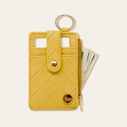 mustard woven keychain wallet with card in slot and cash in zip pocket.